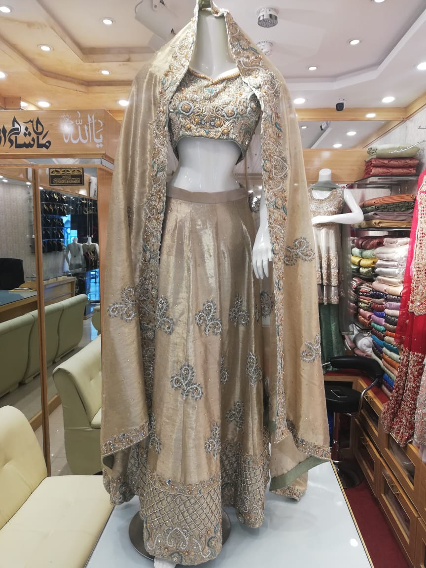 A champagne and gold lehenga choli on display at the Chand Bridals atelier in F-7, Islamabad